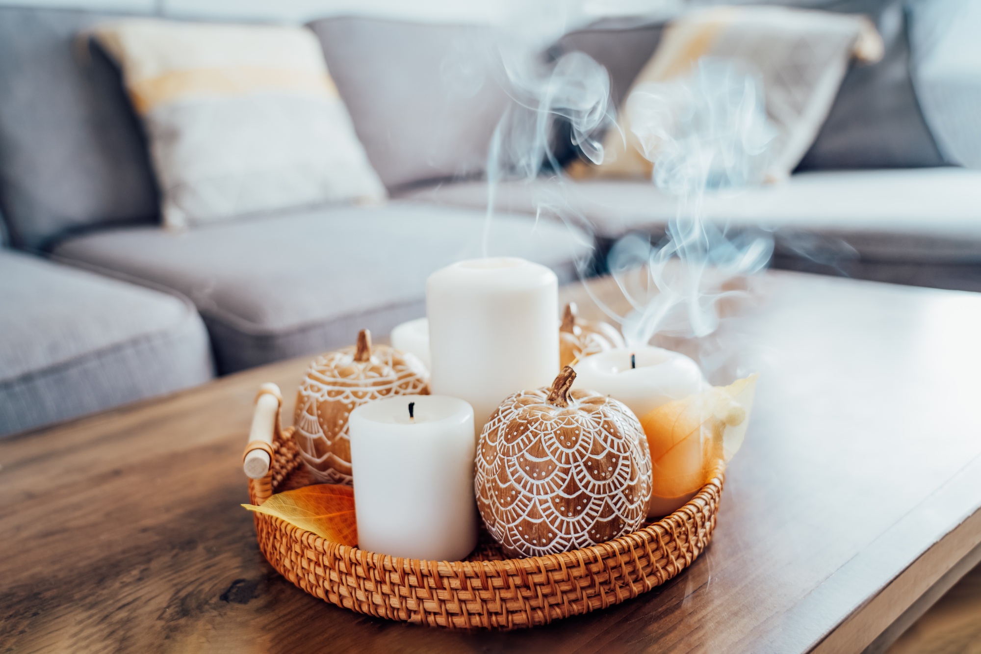 Autumn fall cozy mood composition for hygge home decor. Orange pumpkins decorated with mandalas,