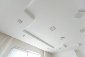 Classic white glossy ceiling with recessed spotlights