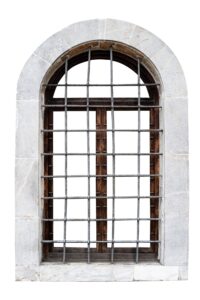 vintage window with stone marble frame protected with metallic railing bars isolated on white